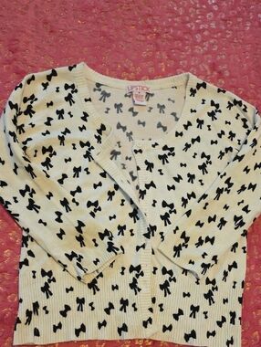 Lipstick Boutique Cream Cardigan with Black Bow Pattern